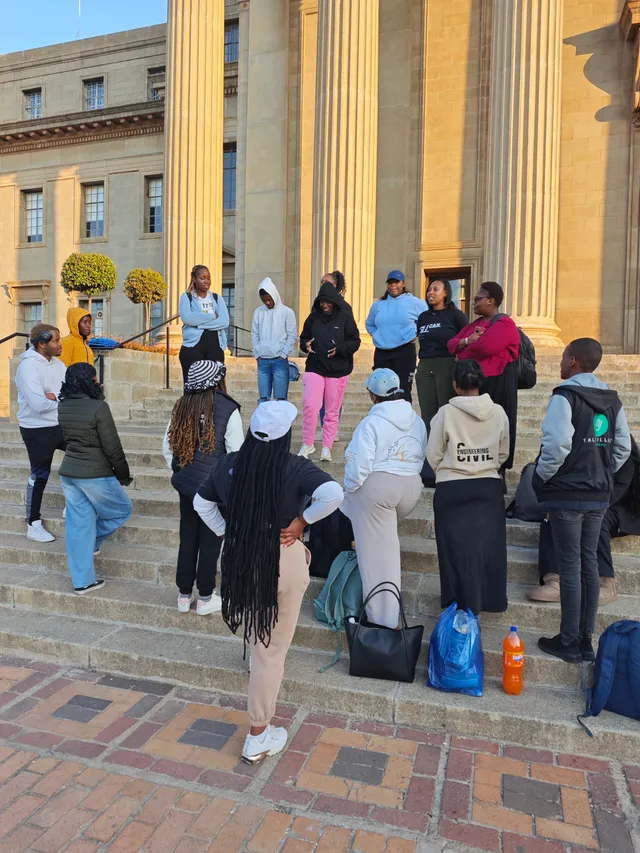 Students gathered together on the Great Hall steps during weekly outreach